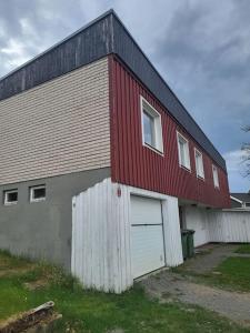 a red and white building with a garage at Villa Tenhult in Tenhult