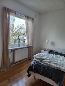 a bedroom with a bed and a window at Villa Tenhult in Tenhult +9 photos