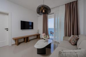 a living room with a couch and a tv at Bliss Apartments in Sutomore