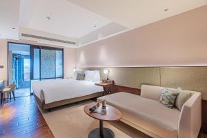 Ένα ή περισσότερα κρεβάτια σε δωμάτιο στο Kilin Hotel, JiaoXi