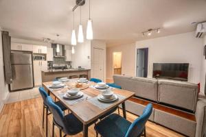 a kitchen and dining room with a table and chairs at Modern 3BR 4beds apartment AC WiFi Free Parking in Laval