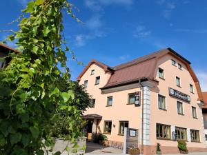 a building with a sign on the side of it at Hotel Garni Edelweiß in Siegsdorf