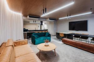 a living room with a couch and a tv and a table at OBO Casa • Modern Lux Design Loft • Ipanema Beach in Rio de Janeiro