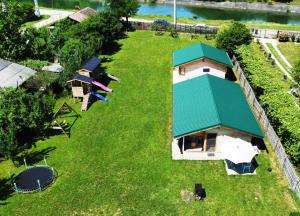 an aerial view of a small house with a green roof at LA LIVADA in Valea Danului