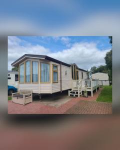 ein kleines Haus steht auf einer gemauerten Auffahrt in der Unterkunft Mallard's Retreat Holiday Home at Port Carlisle near Bowness on Solway in Port Carlisle