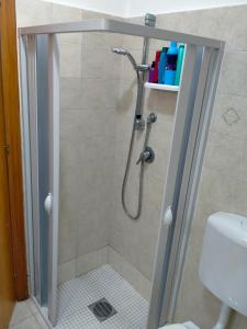 a shower with a glass door in a bathroom at Solemare in Gioiosa Marea