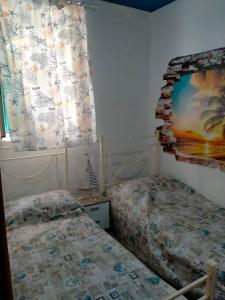 a bedroom with two beds and a window at Solemare in Gioiosa Marea
