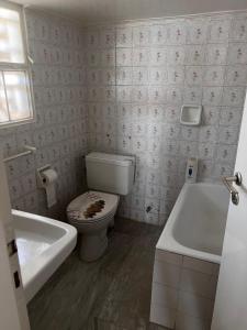 a bathroom with a toilet and a tub and a sink at Athens Palaia Fokaia Entire Flat 2 bedrooms with panoramic sea views and a massive veranda , only steps away from the beach and amenities in Palaiá Fókaia
