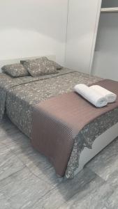 a bedroom with a bed in a room at Athens Palaia Fokaia Entire Flat 2 bedrooms with panoramic sea views and a massive veranda , only steps away from the beach and amenities in Palaiá Fókaia