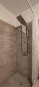 a bathroom with a shower with a shower curtain at Bari am See in Borsodbóta
