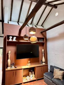 a living room with a tv and a couch at Casa Villa María, Recién Remodelada in Villa de Leyva