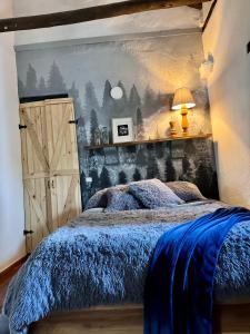 a bedroom with a bed with a blue comforter at Casa Villa María, Recién Remodelada in Villa de Leyva +25 photos