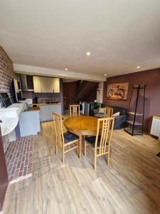 a kitchen and dining room with a table and chairs at Maisonnette de la Butte de Thil in Nan-sous-Thil +9 photos