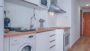 a kitchen with a sink and a washing machine at Apartamento Fani Oro in Oropesa del Mar