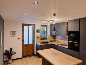 a kitchen with a wooden counter and a kitchen island at Apartment Mija Rabac with free parking in a garage in Rabac