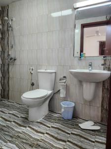 a bathroom with a toilet and a sink at iQama 2 in Salalah +24 photos