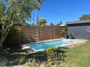 a swimming pool in a yard next to a fence at Terrama de l'isle in LʼIsle-sur-la-Sorgue +6 photos
