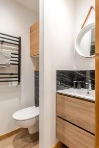 a bathroom with a toilet and a sink at L'Alpage - Serre Chevalier in Saint-Chaffrey