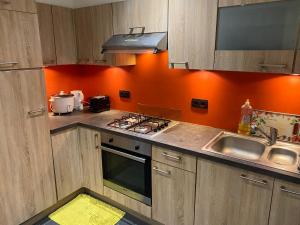 a kitchen with a sink and a stove top oven at Quiet home in Denderleeuw