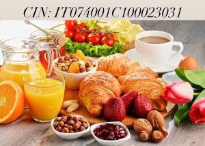 a breakfast table with croissants and fruit and a cup of coffee at Dimora del Casale in Brindisi