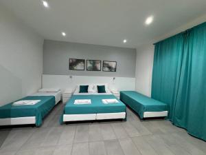 A bed or beds in a room at Affittacamere Sikelia