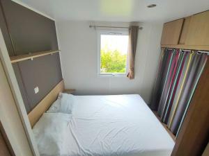 a small bedroom with a bed and a window at Nat & Mayou in Onzain +26 photos