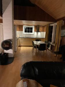 a living room with a couch and a table and a kitchen at Øse Camping in Gratangen