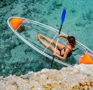 a woman in a boat in the water at Casa Regina in Castelluzzo