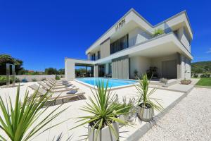 a villa with a swimming pool and a house at Villa La Casa in Bibinje