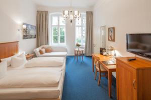 Postel nebo postele na pokoji v ubytování Hotel Brandies an der Messe