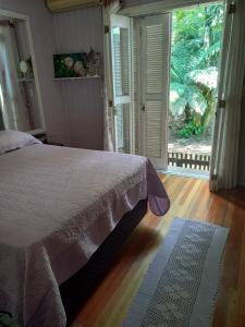 Giường trong phòng chung tại Casa Alpes Verdes Canela RS
