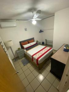 a bedroom with a bed and a ceiling fan at Departamento Vallarta in Puerto Vallarta