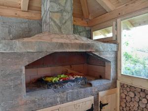 an outdoor oven with fruits and vegetables in it at La Casa Sofija in Nemenikuće