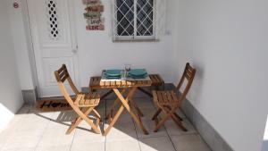 a table with two chairs and a plate on it at Guest House CR5 in Porto