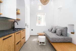 a living room with a couch and a table at Skepi Town Houses in Mikonos
