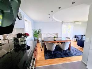 a dining room and living room with a table and chairs at Bergen Sunrise Terrace Apartment in Bergen