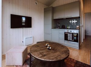 a living room with a table and a kitchen at Marstastugorna in Uppsala