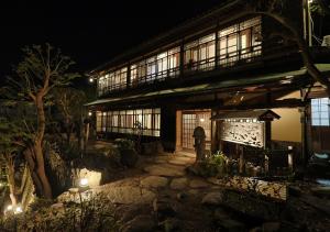 a building with lights in front of it at night at 虎屋別館 in Kotohira