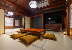 a living room with a table and two cushioned at 虎屋別館 in Kotohira +52 photos