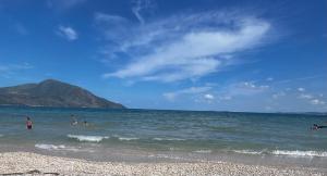 a group of people in the water at the beach at K Bougainville Albania in Orikum