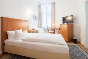 Postel nebo postele na pokoji v ubytování Hotel Brandies an der Messe