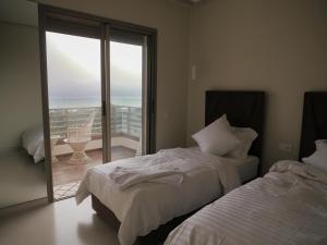 Kama o mga kama sa kuwarto sa Appartement vue océan