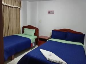 Postel nebo postele na pokoji v ubytování Hotel Manhattan City