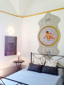 a bedroom with a bed with a picture on the wall at Amalfi 2 rooms 1fl no terrace 2fl private terrace sea view in Atrani