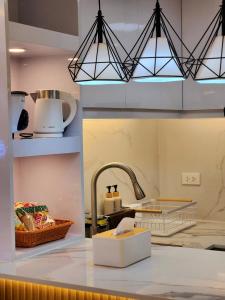 a kitchen with a sink and a counter top at SleepScape Staycation in Manila