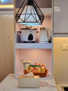 a refrigerator with a basket of food and a light at SleepScape Staycation in Manila