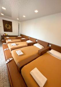 a row of beds lined up in a room at De Pointé Resort & Resto in Campaka