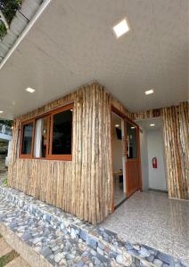 a house being built with a log wall at De Pointé Resort & Resto in Campaka