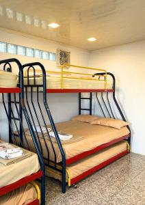 a room with two bunk beds in a dorm room at De Pointé Resort & Resto in Campaka
