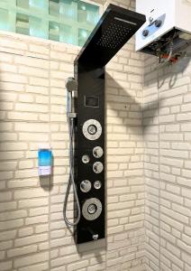 a wall with a shower in a bathroom at De Pointé Resort & Resto in Campaka
